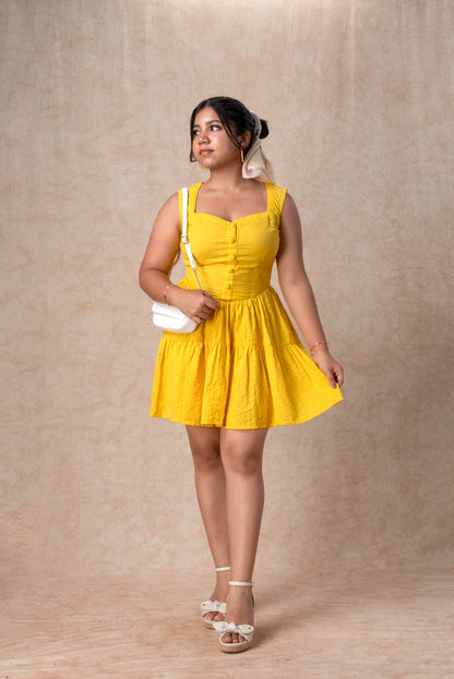 Woman wearing a yellow dress against a beige background